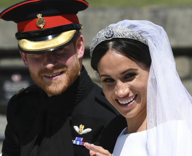 FILE - In this May 19, 2018, file photo, Britain's Prince Harry, Duke of Sussex and his wife Meghan Markle, Duchess of Sussex wave from the Ascot Landau Carriage during their carriage procession on Castle Hill outside Windsor Castle in Windsor, England after their wedding ceremony. With two blockbuster British royal weddings this year and an enduring fascination with the Brits, American brides craving a regal look with personal twists can find plenty of inspiration. (Paul Ellis/pool photo via AP, File)